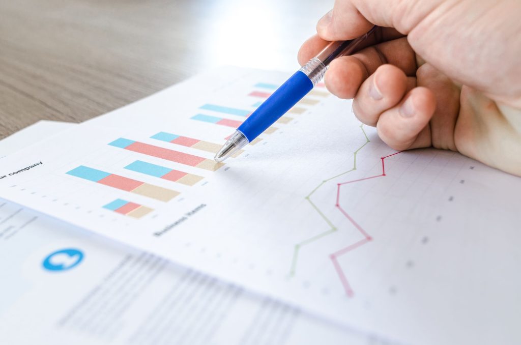 Digital marketing analyst reviewing Google Ads campaign performance metrics on computer dashboard