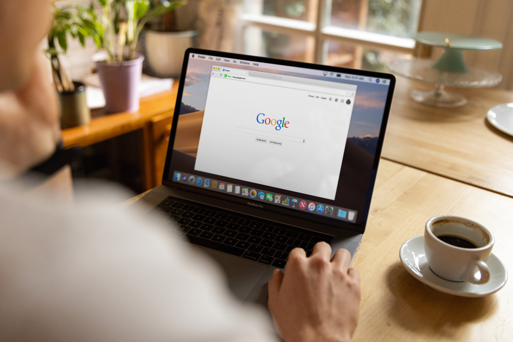 Small business owner managing PPC advertising campaigns on laptop