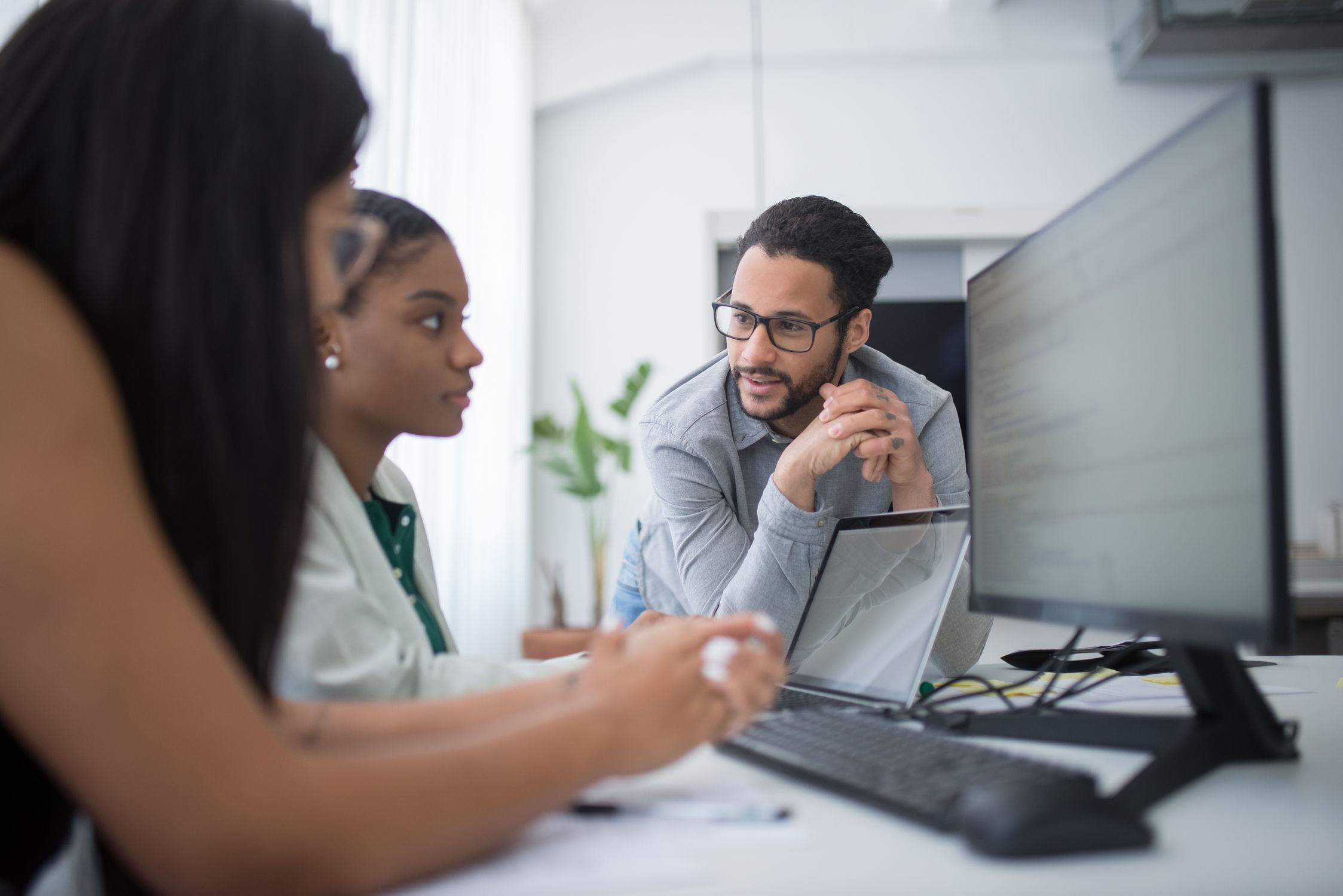 Business professionals analyzing B2B Google Ads lead generation data on laptop in modern office
